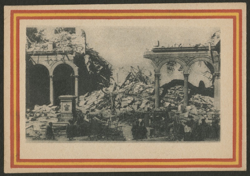 Front of postcard (recto). Image of a photograph of a building or structure in ruins. There is a line of columns with an opening in the middle. In the opening, there is a large pile of debris. The photograph has a red and yellow striped border. 