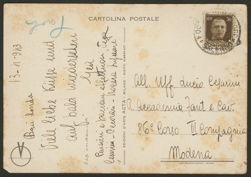 Back of postcard (verso). Image of a used back side of a postcard. The title is "Cartolina Postale". There is a stamp of a man in the upper right corner. The stamp is labeled "cent. 30 Poste Italiane" and has another black stamp on top. There is a circle symbol with a V in the center in the bottom left corner. The postcard includes handwriting (handwriting is unclear). Full text includes "Cartolina Postale cent. 30 Poste Italiane Edizioni D'arte Acta Milano Diritti Riservati Arti Grafiche Matelli - Milano".